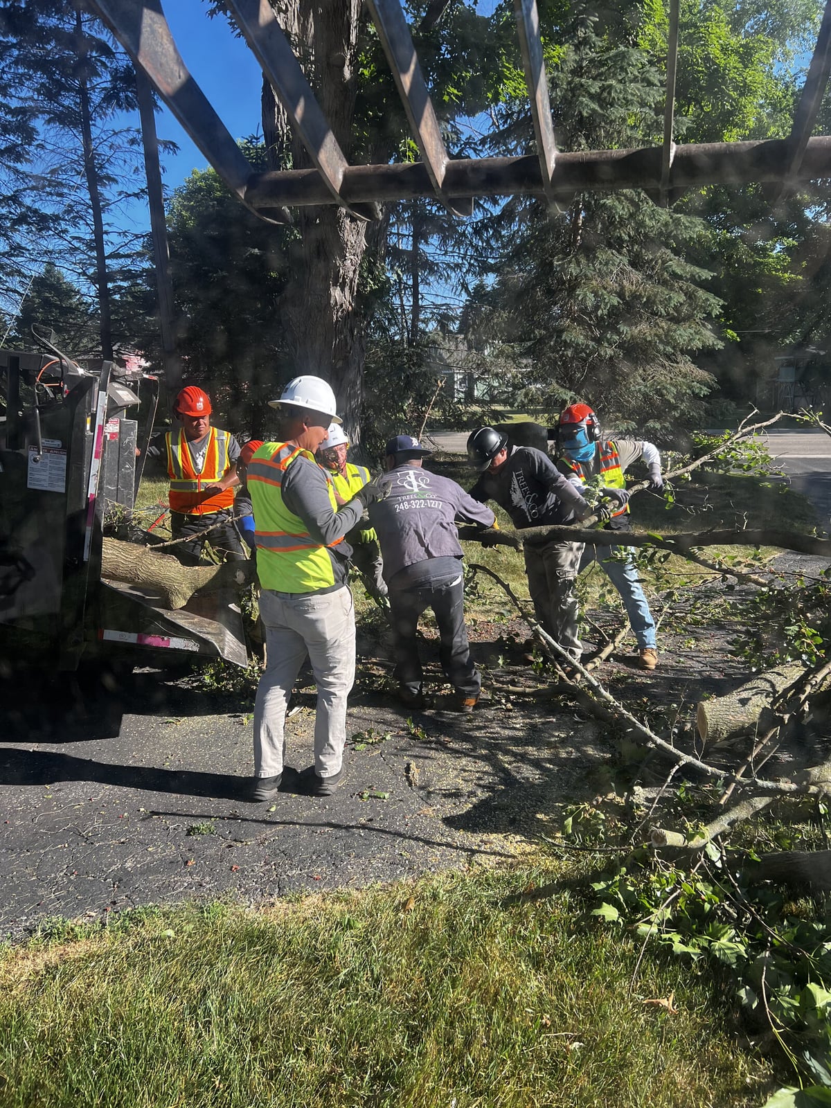 Trees and Co. crew clearing roadside storm damage in Oakland County